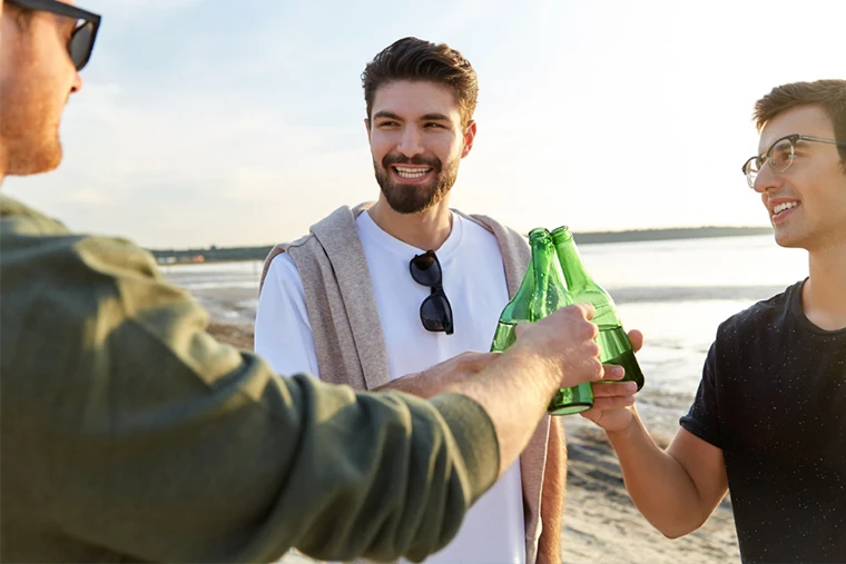 Male Friends Enjoying Beer on the Beach